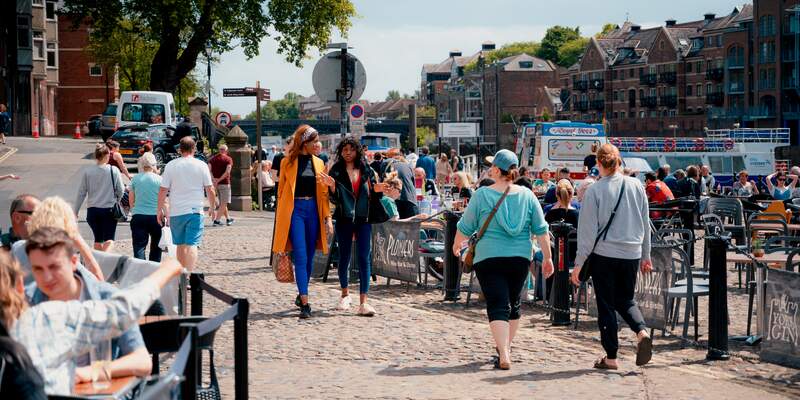 People walking by the River Ouse in York